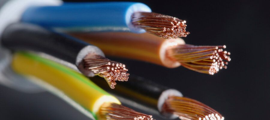 Close-up of stripped copper cable cores in blue, brown, black and green-and-yellow